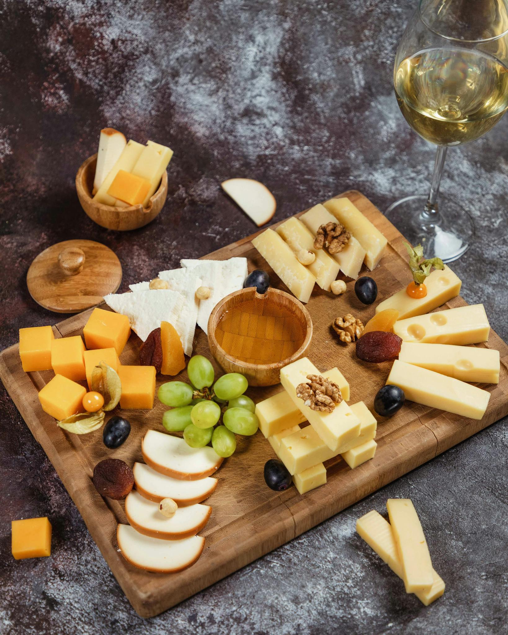 Cheese platter, snacks and white wine . Overhead